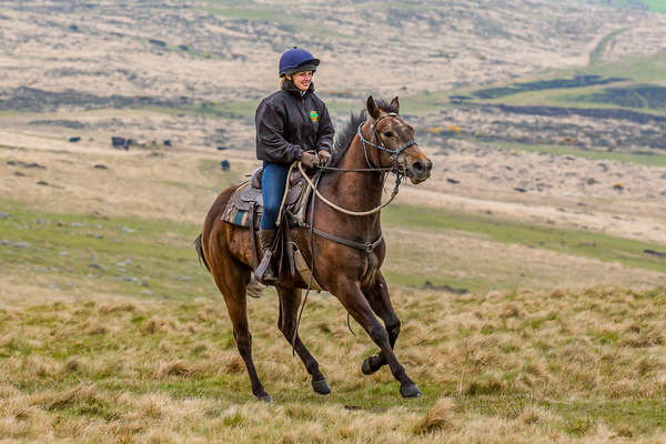 Rider enjoying a great canter in western tack in Devon