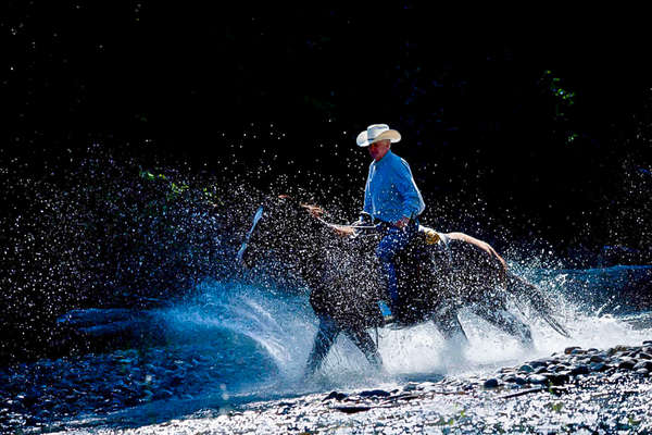 Rider on a trail at the Three Bars guest ranch