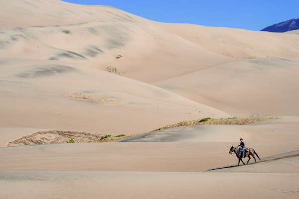 Rider on a trail ride at Zapata Ranch, Colorado