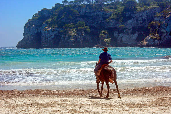 Rider riding his horse into the Mediterranean in Spain