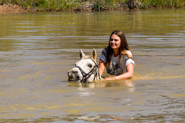Rider swimming in a horse in South Africa