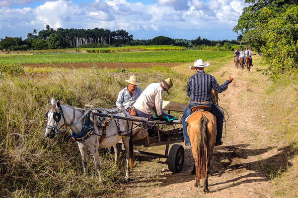 Rider talking to locals on the trail in Cuba