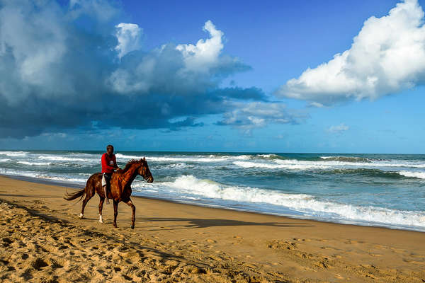 Rider walking on the beach in Madagascar