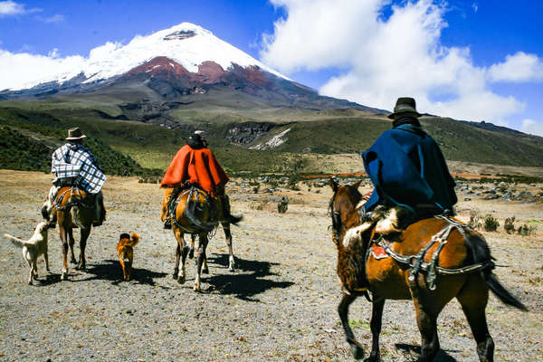 Riders approaching Cotopaxi volcano