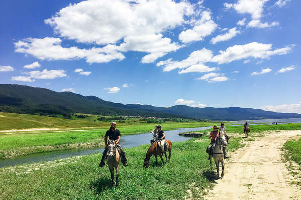 Riders by a lake in Bulgaria