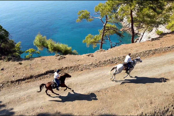 Riders cantering along a off the beaten track in Turkey