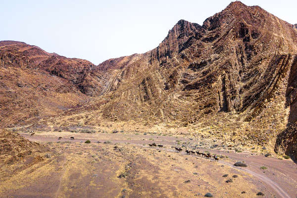 Riders crossing a canyon in Damaraland, Namibia