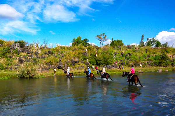 Riders crossing a river in Madagascar