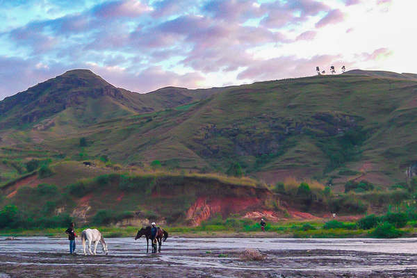 Riders guiding the horses through the lake in Madagascar