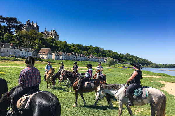 Riders near a village in France and next to a river