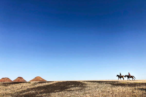 Riders on a beautiful desert-like scenery in Namibia