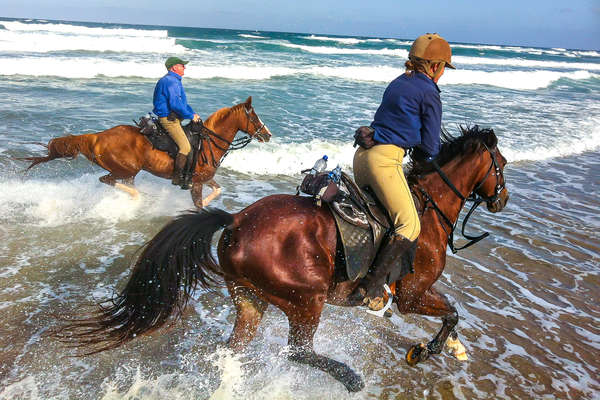 Riders on a fast trail ride on the Wild Coast of South Africa