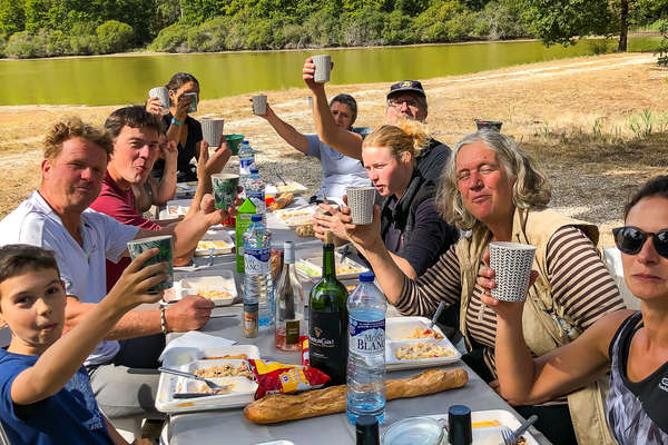 Riders on a horseback vacation having a picnic lunch