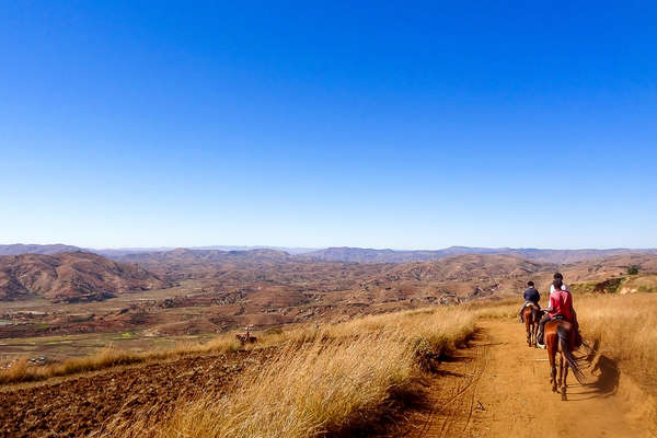 Riders passing through a semi-arid desert in Madagascar