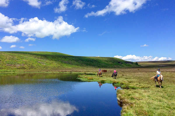 Riders riding around a lake in Wales