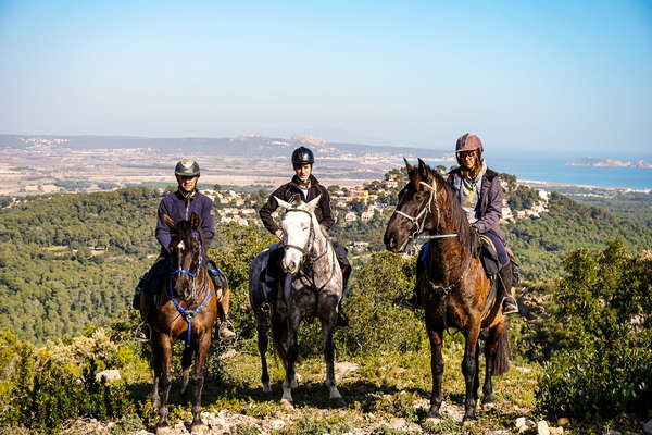 Riders standing on a hill with beautiful views of the Costa Brava
