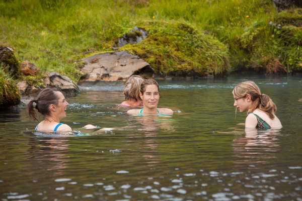 Riders swimming in a lake