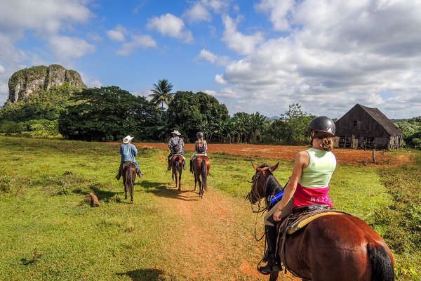 Riders walking along a trail in Cuba