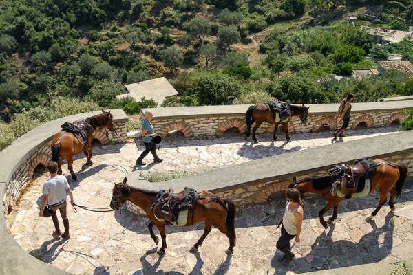 Riders walking down a ramp in Albania