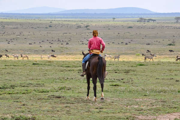 Riders watching wildlife in Tanzania during the wildebeest migration
