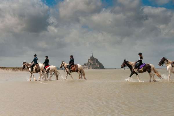 Riding with the Mt St Michel in the background, France