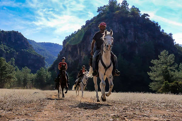 Three riders on a trail in Turkey
