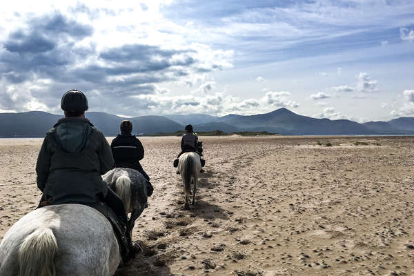 Trail riders riding on an Irish beach in Kerry