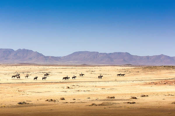 Trail riding on horseback in Damaraland in Namibia