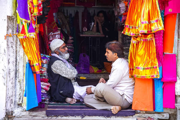 Two Indian men inside a shop