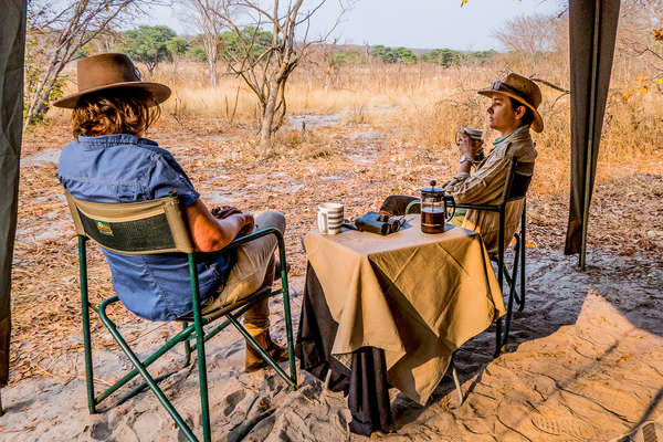 Two people enjoying coffe in their tent in Zimbabwe