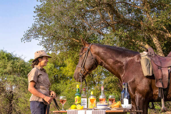 Woman admiring her horse in Botswana