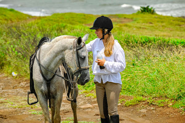 Woman resting side by side her horse in Costa Rica