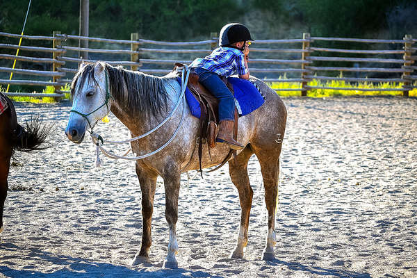 Young rider enjoying a western riding lesson in Montana