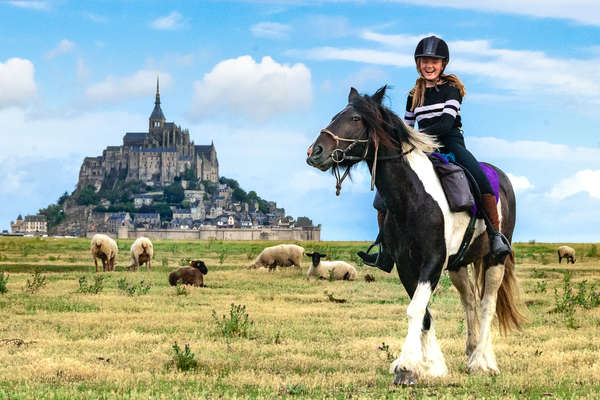 Young riders laughing on a horseback vacation in France